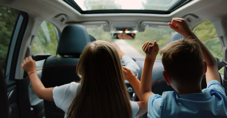 Family enjoying time inside a car with privacy protection window film, ensuring clear vision and anti-peeping safety.
